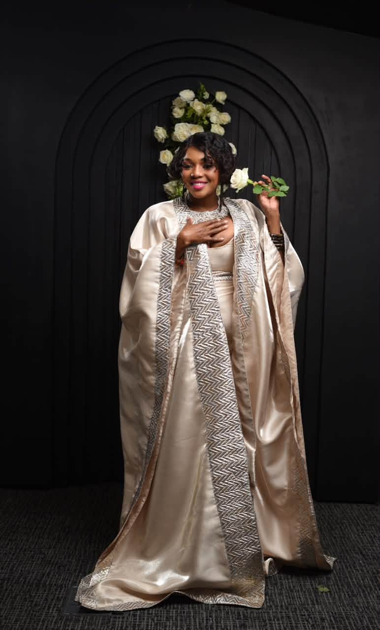 Kearoma Rantao in a champagne satin robe holding a white rose